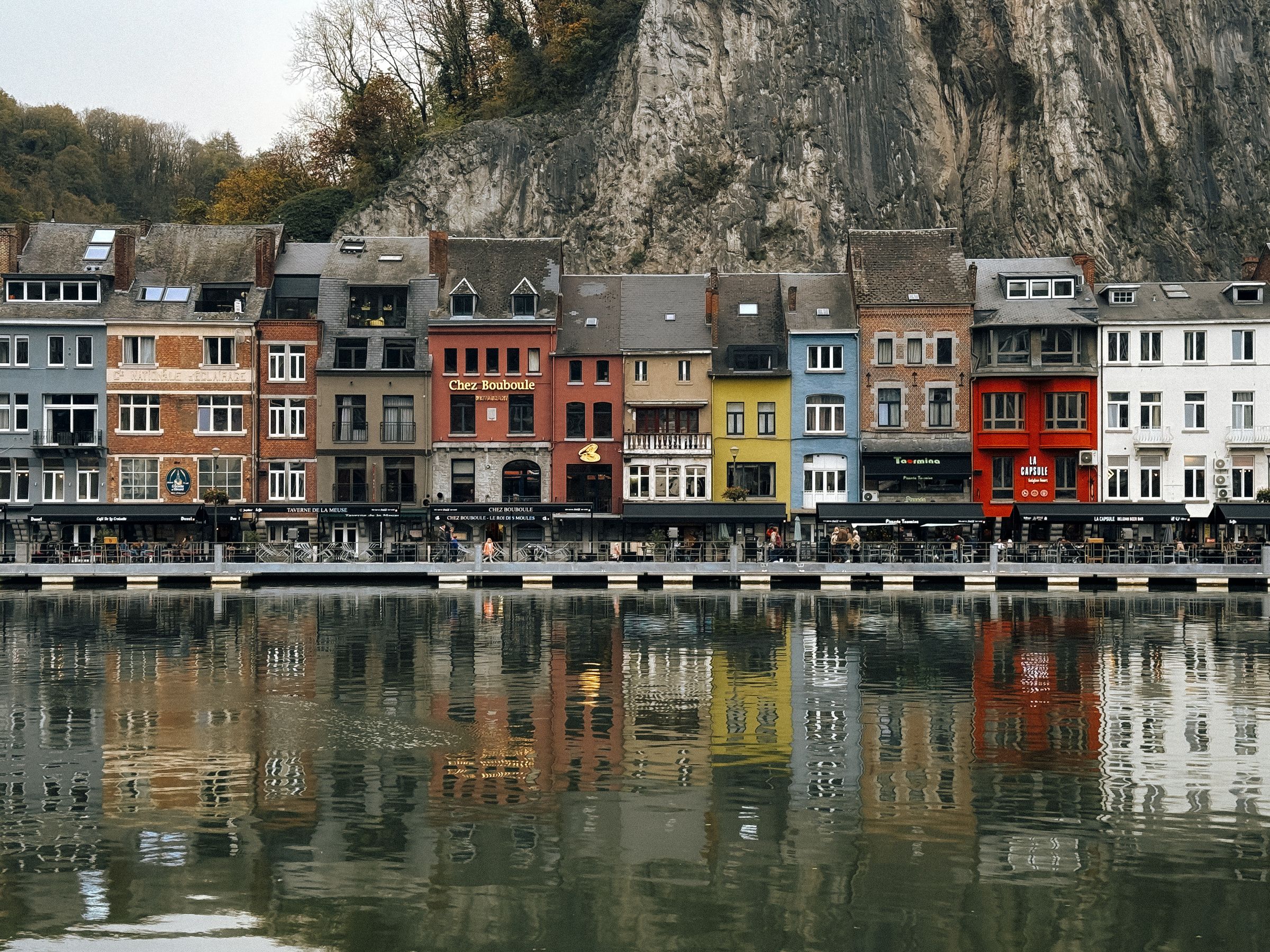 Colorful houses reflected in the Meuse River in Dinant, Belgium