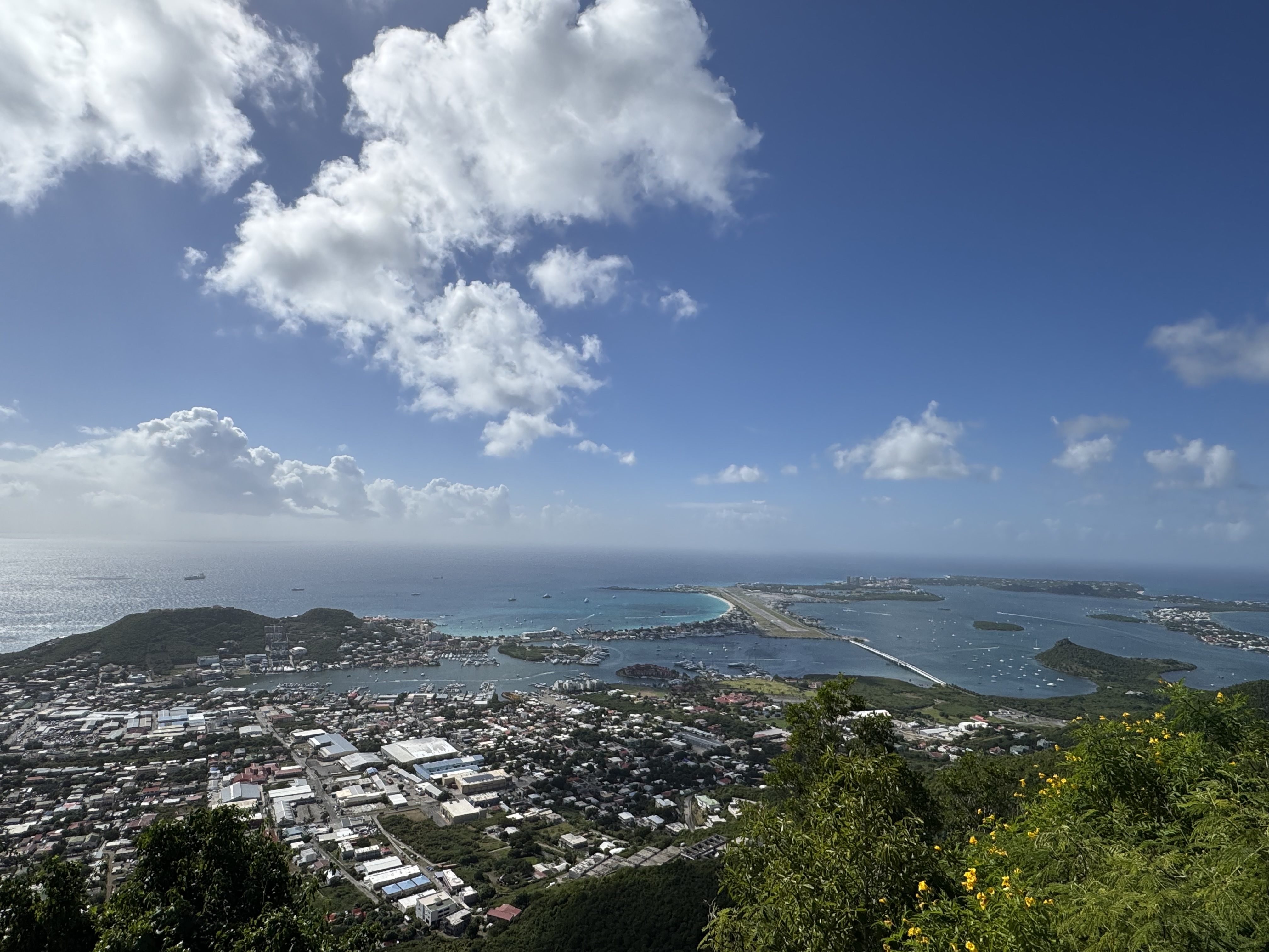 Aerial view across western Sint Maarten, its coastline, lagoon, and airport